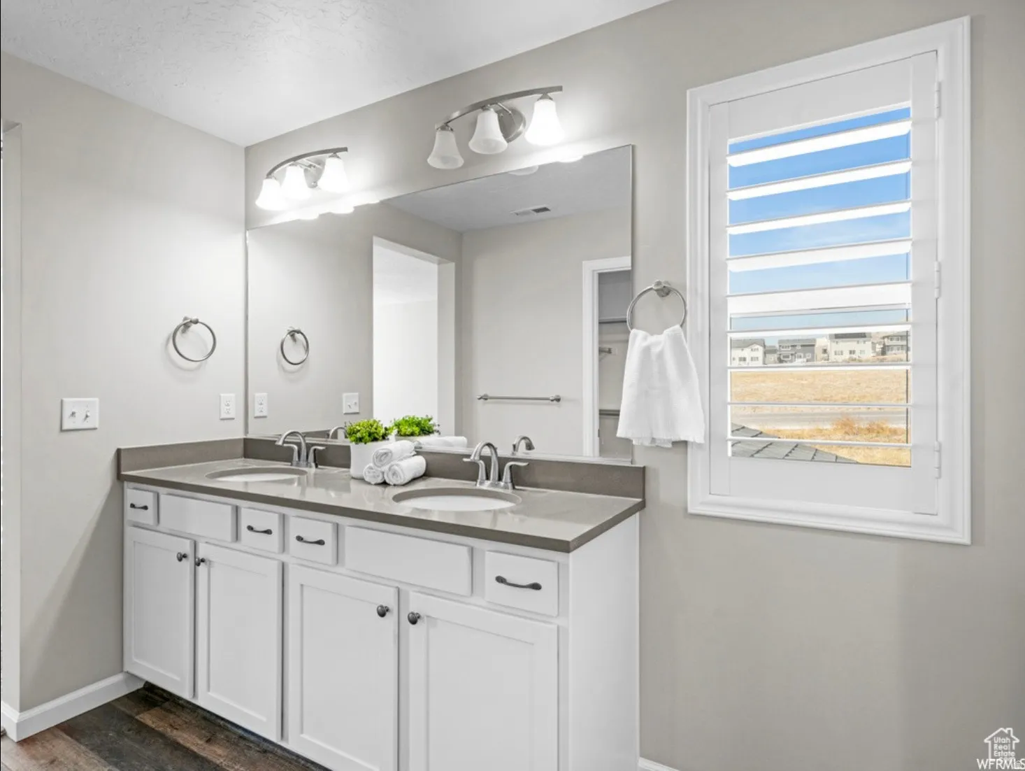 Double vanity with undermount sinks and dark grey countertops