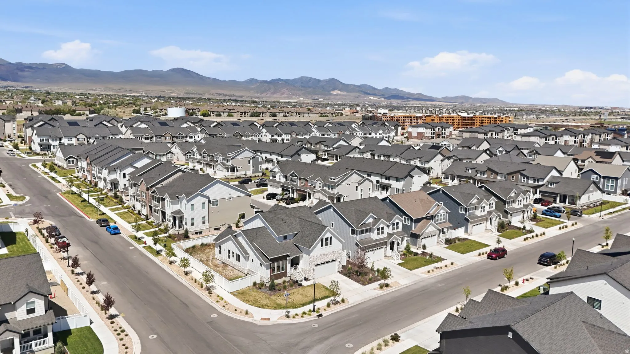 Expansive neighborhood featuring numerous two-story residences with varied architectural styles and dark-shingle roofing