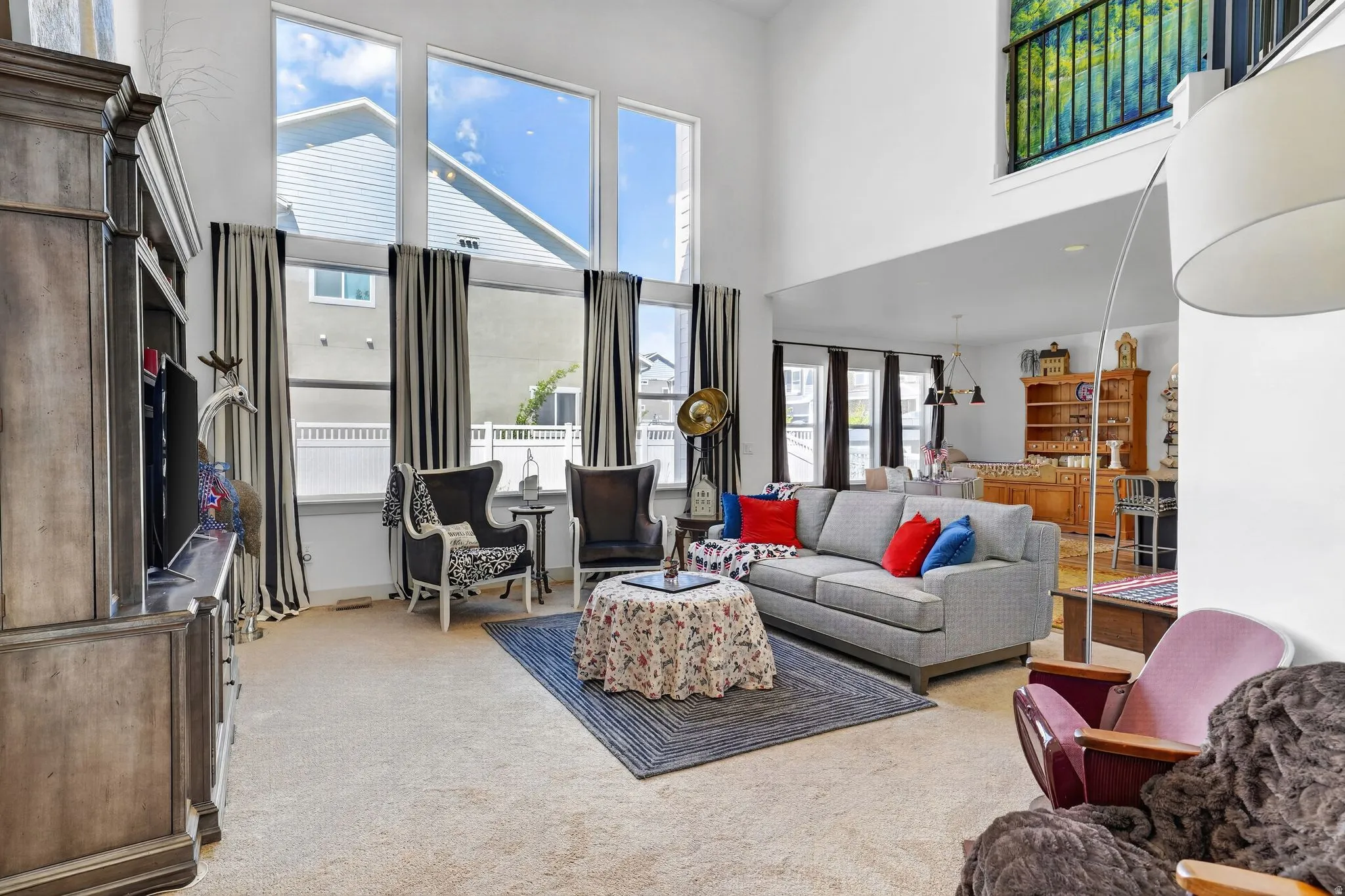 Great room featuring high ceilings and multiple large windows