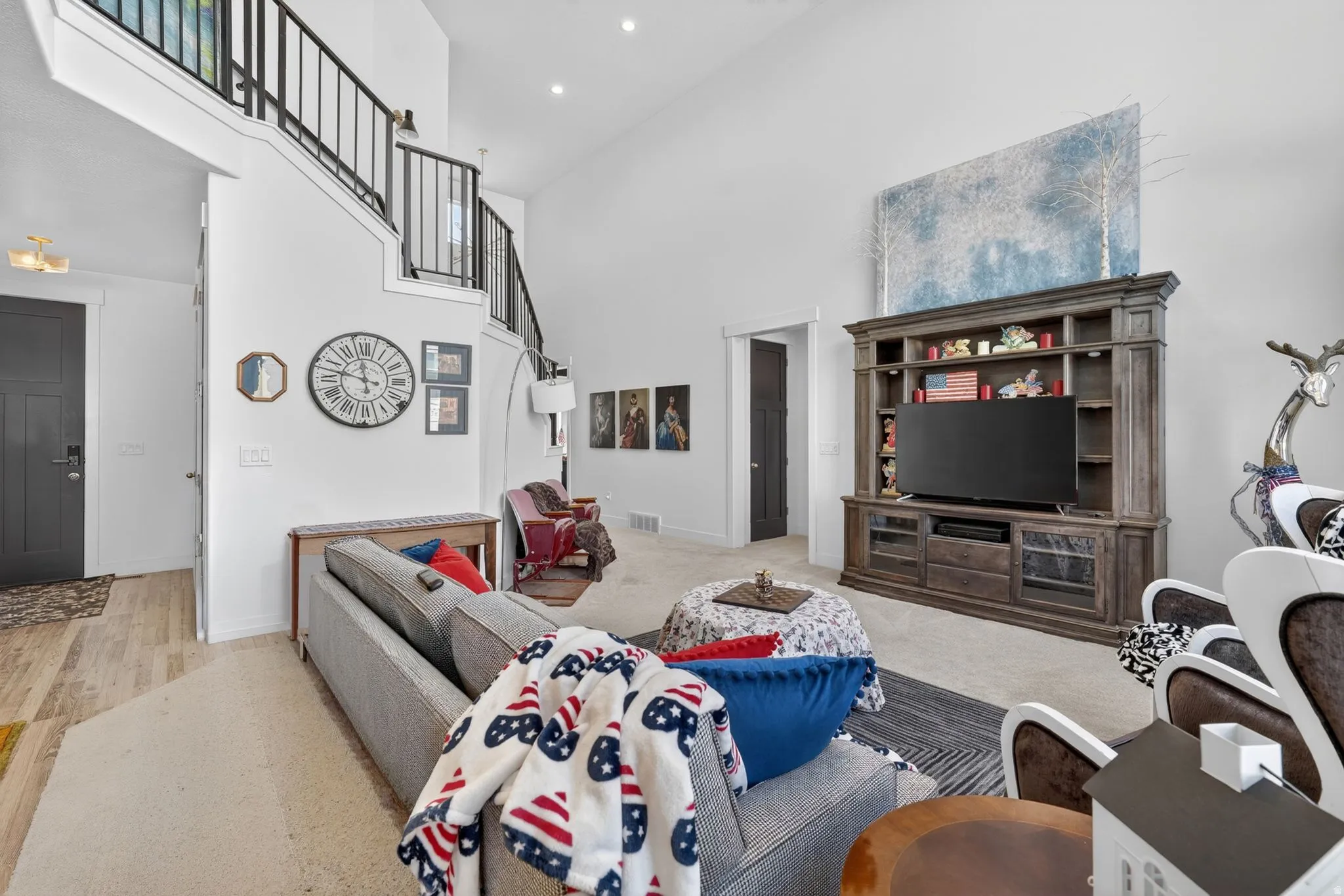 Expansive living area featuring soaring ceilings and recessed lighting