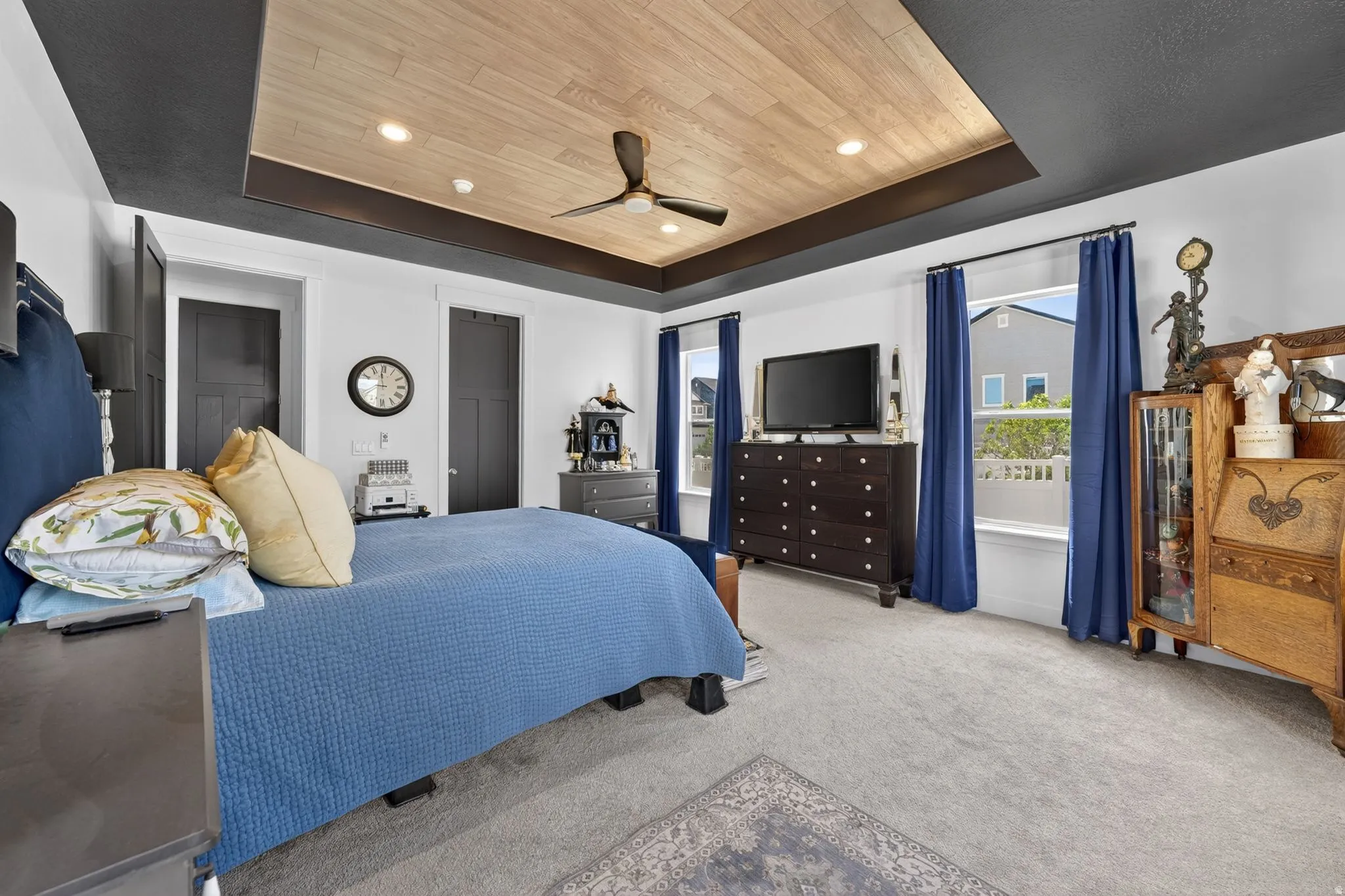 Recessed ceiling with wood-finish paneling and a ceiling fan