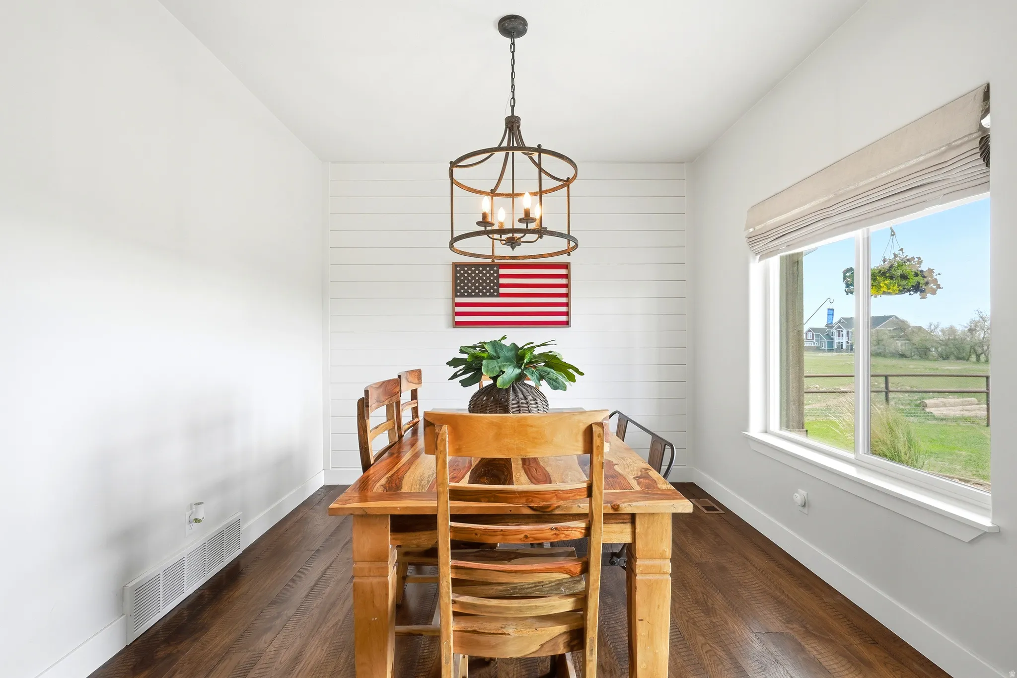 DINING AREA WITH AN AWESOME CONTEMPORARY CHANDELIAR AND SHIPLAP ACCENT WALL!