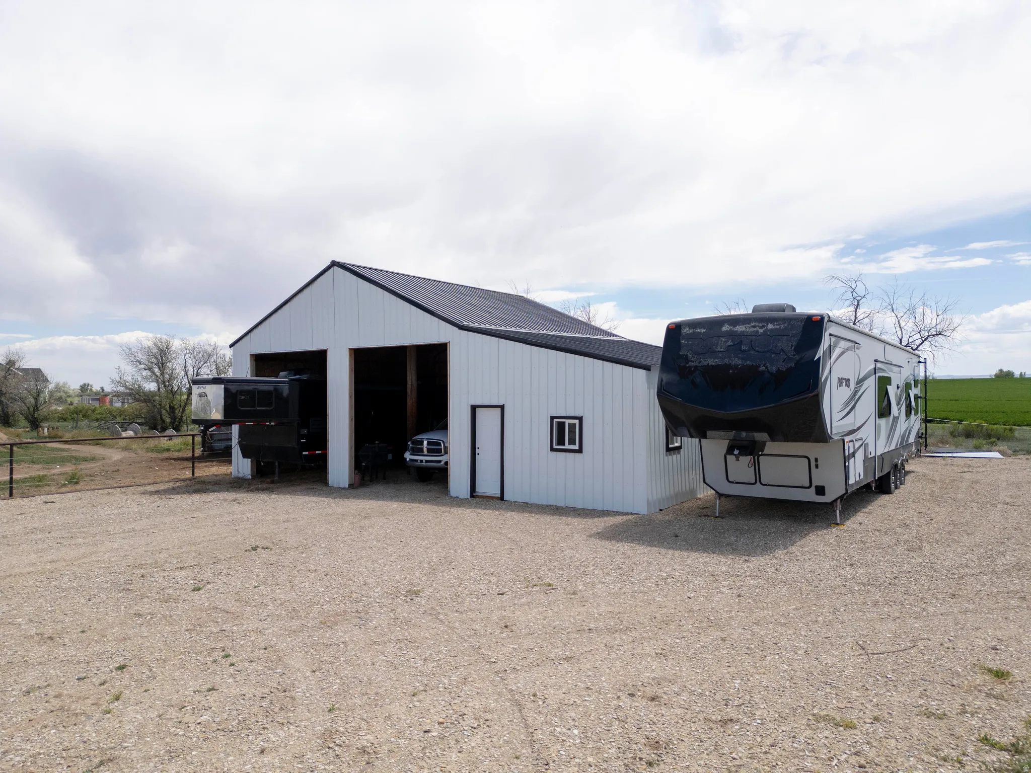 Detached garage structure with two large bays, a side entry door, and a small window