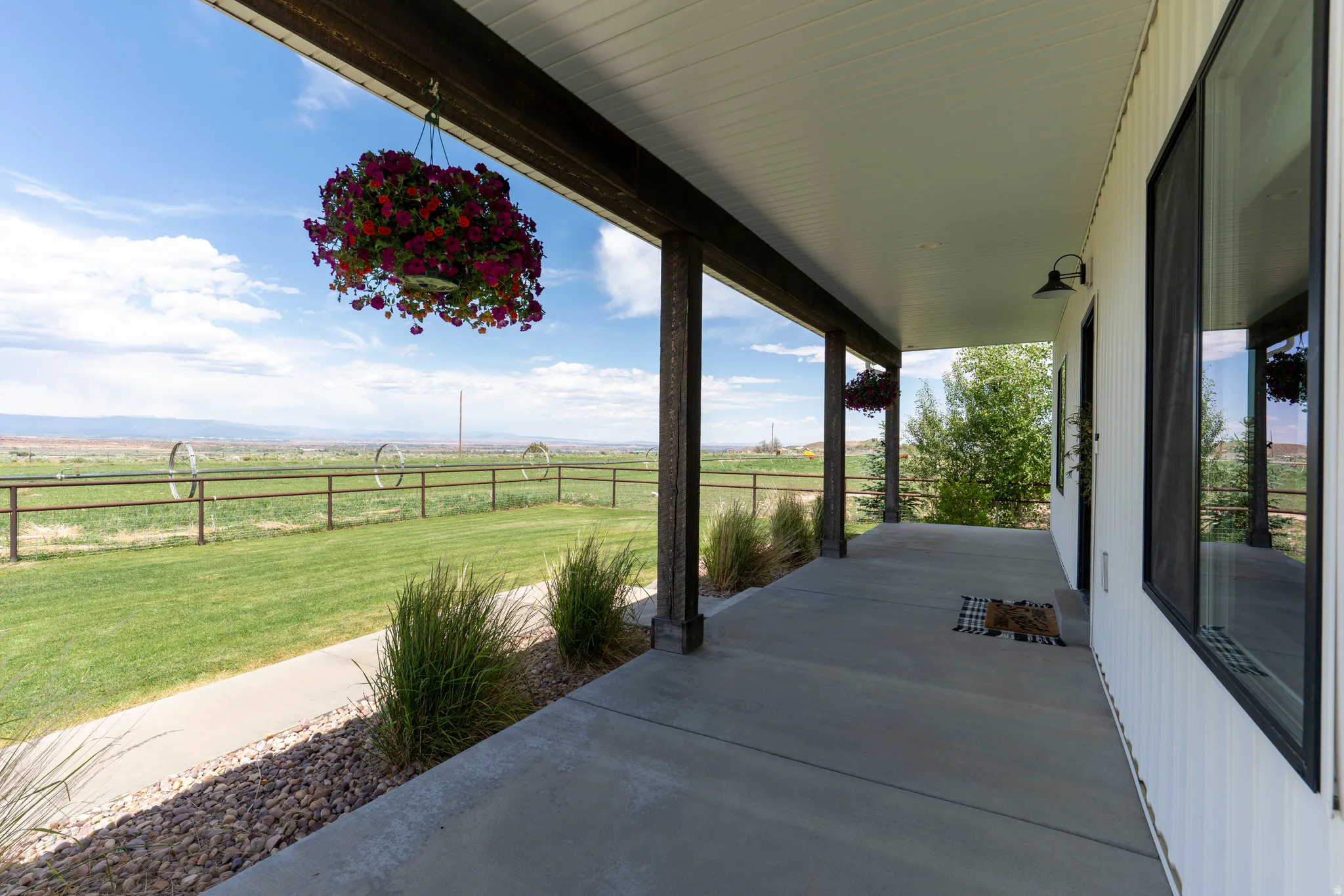 Expansive covered patio featuring a concrete surface and a white paneled ceiling