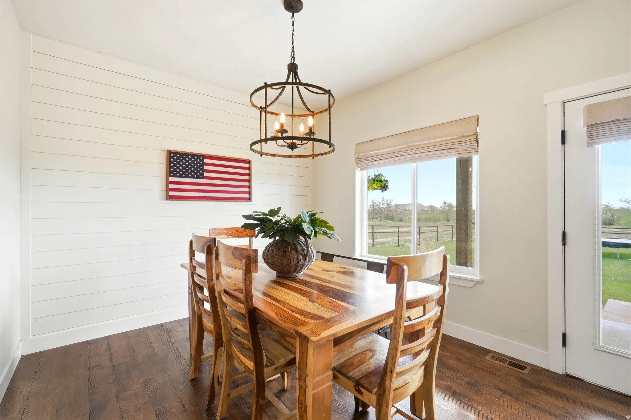 DINING AREA WITH LOTS OF LIGHT COMING IN! DOOR OFF THE DINING ROOM WILL TAKE YOU TO THE BACK COVERED PORCH!