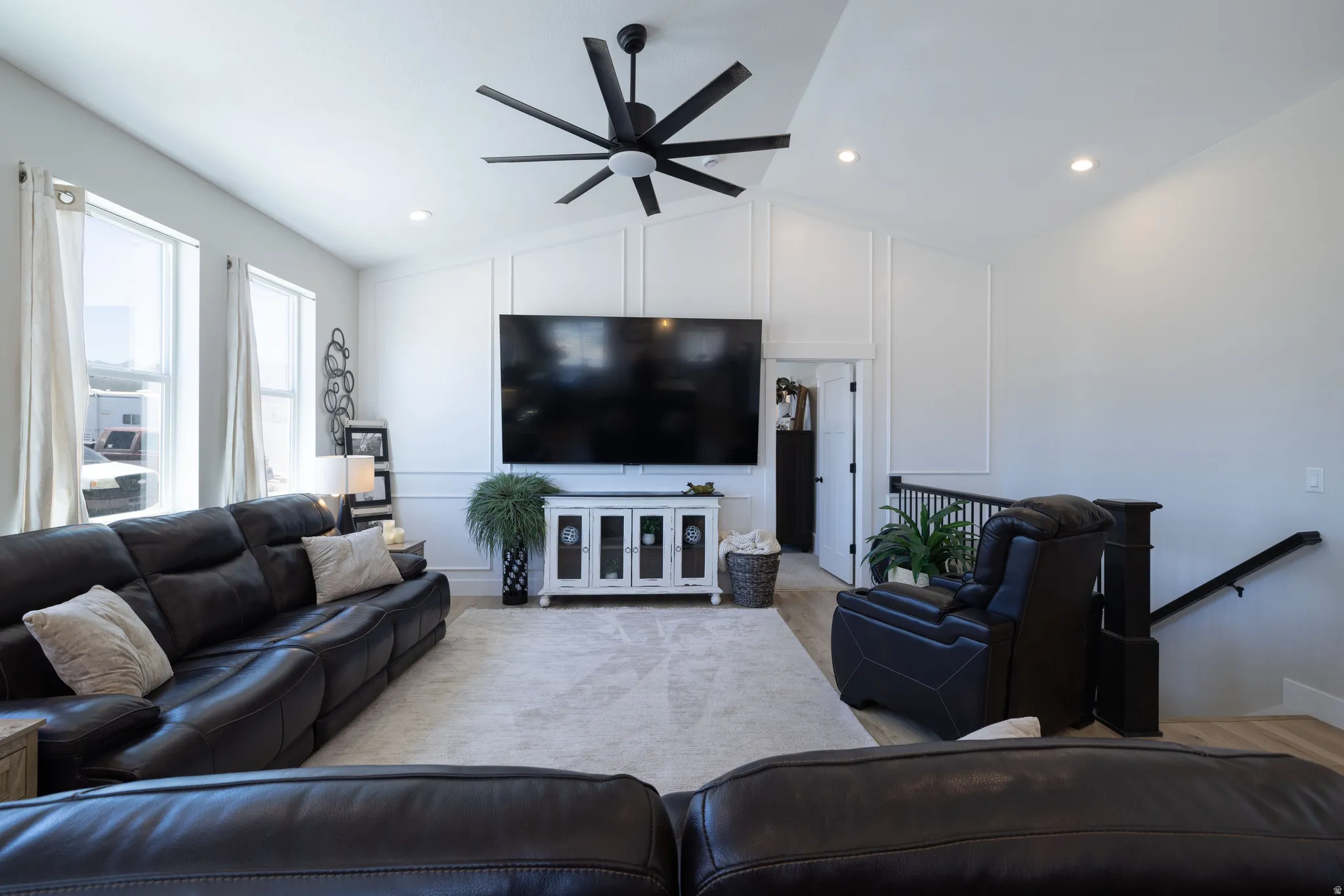 Vaulted ceilings with recessed lighting and a large ceiling fan