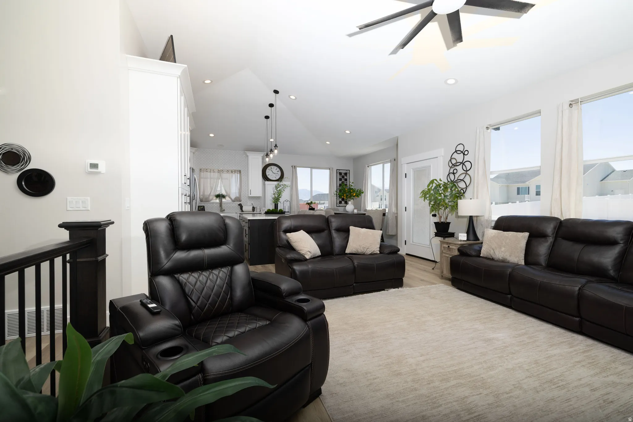 Open-concept living space featuring wood-finish flooring, recessed lighting, and a contemporary ceiling fan