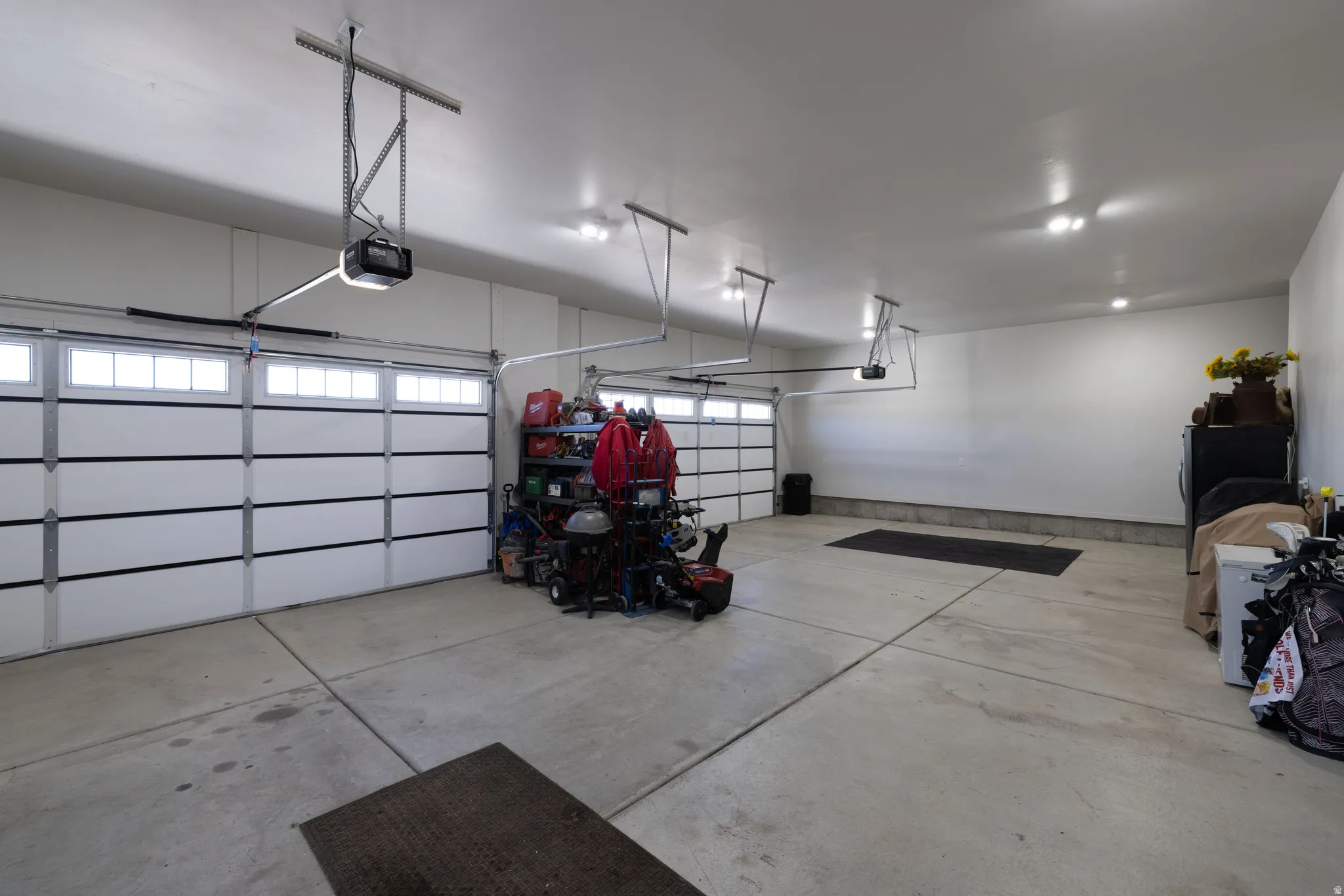 Spacious 4-car garage featuring automatic openers and overhead lighting