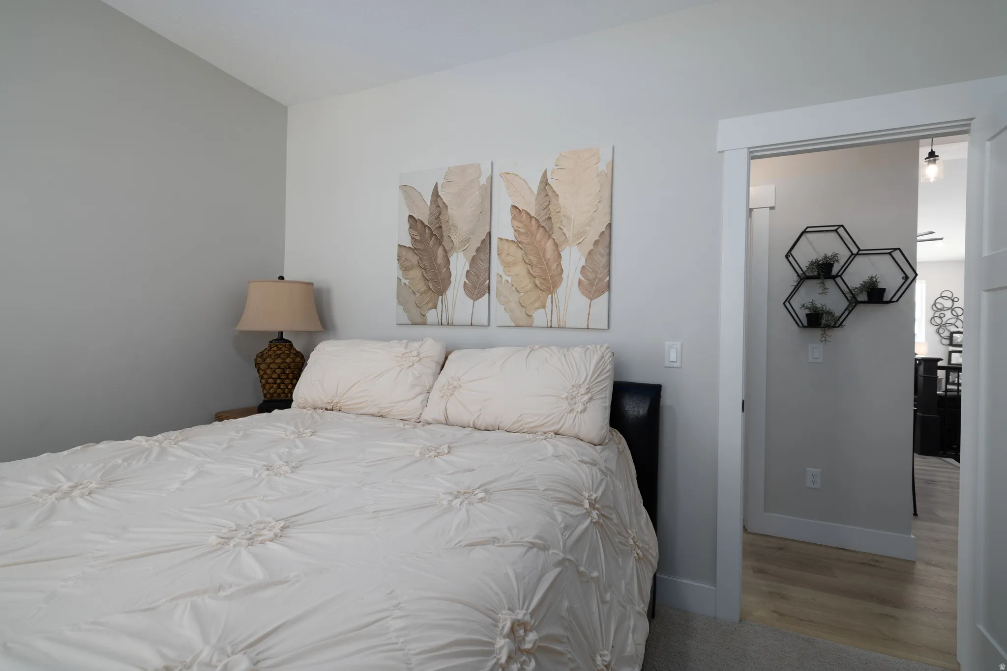 Carpeted bedroom featuring light gray painted walls and white trim