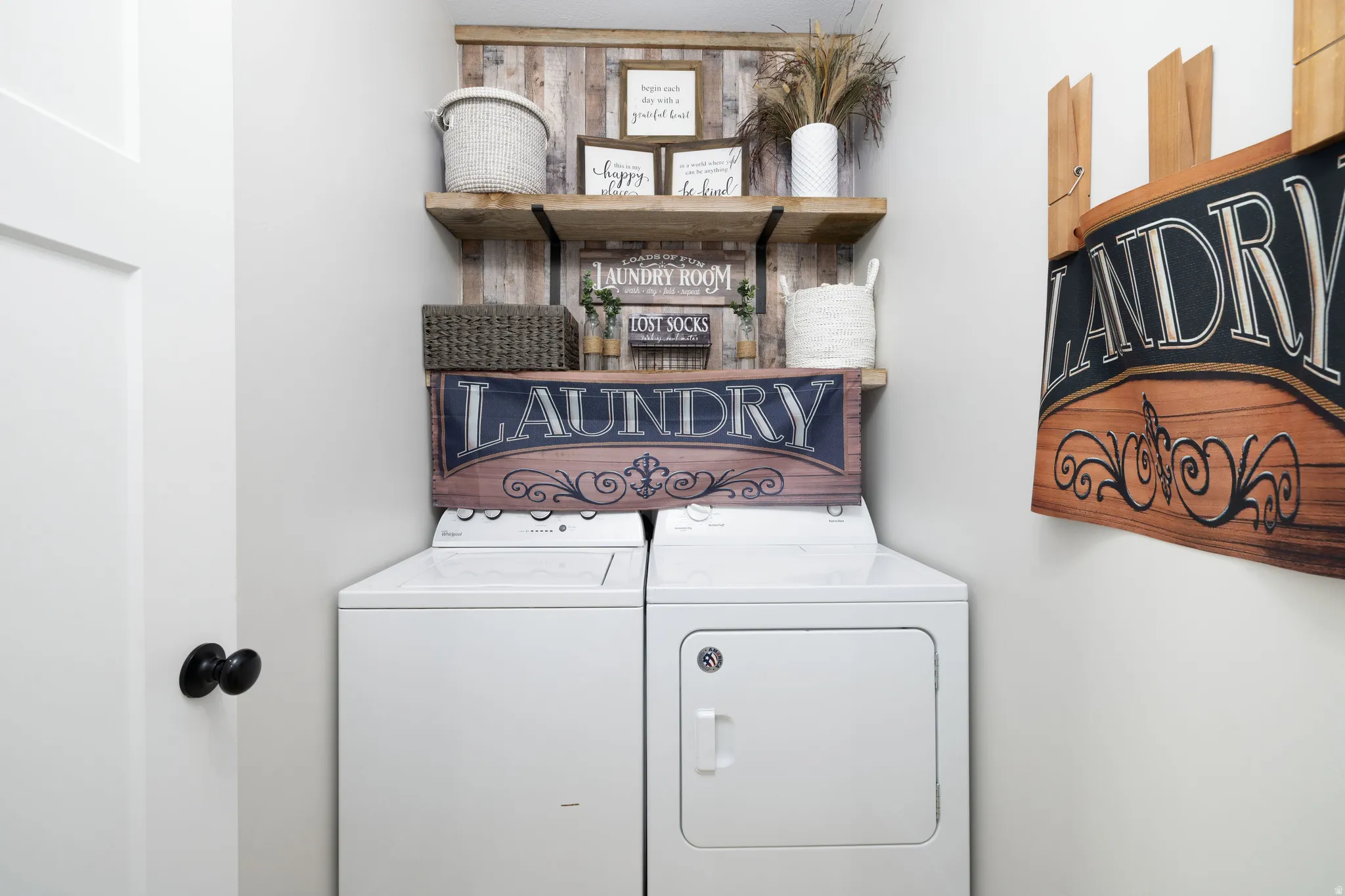 Dedicated laundry area featuring a white washer and dryer pair