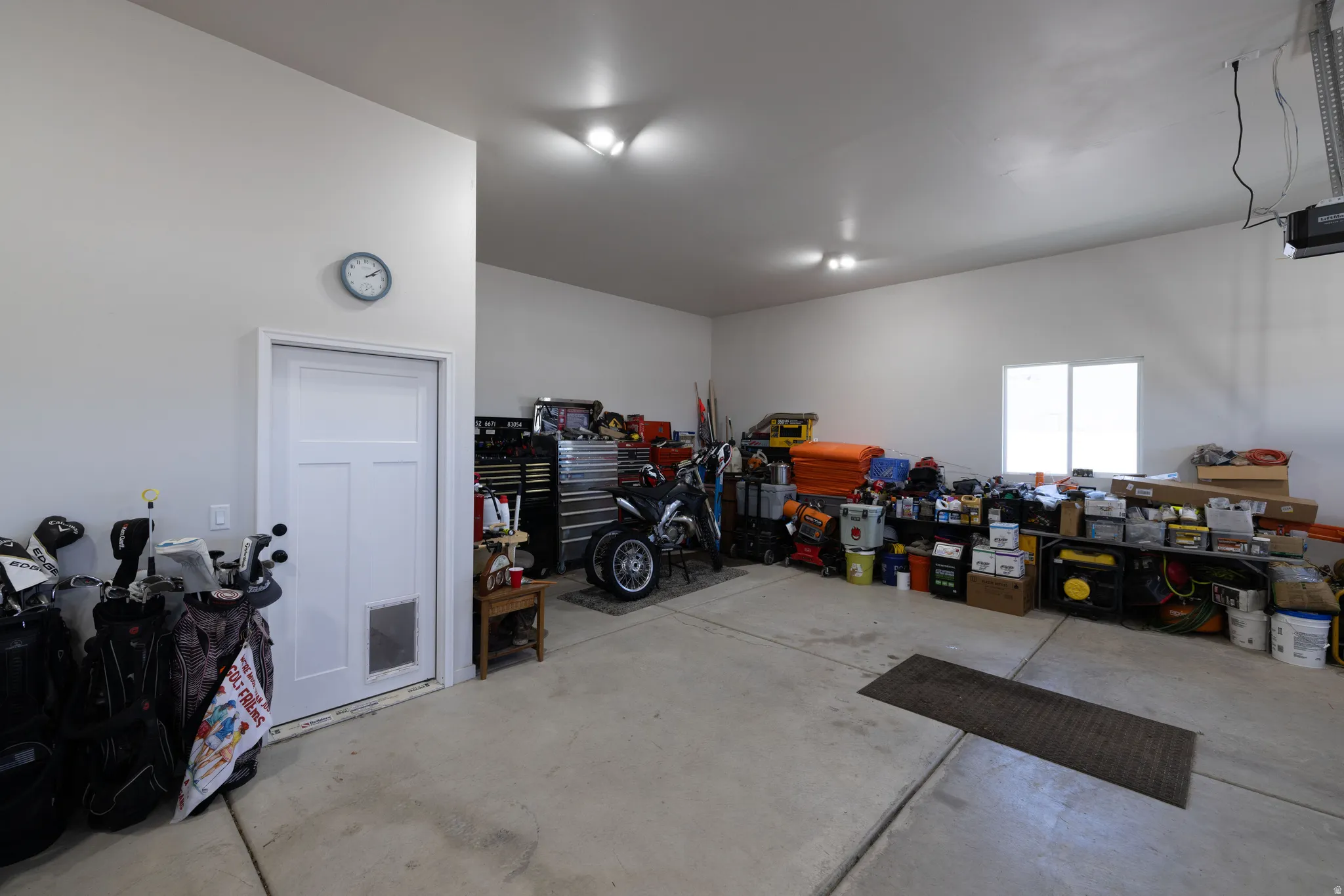Spacious garage featuring concrete flooring and white painted walls