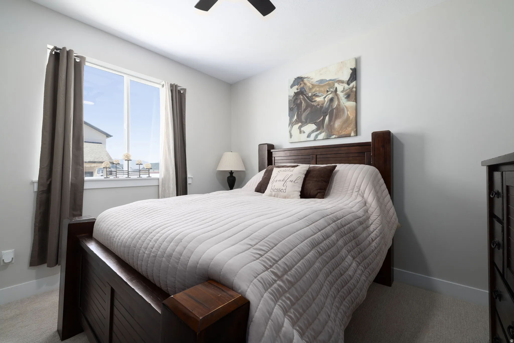 Carpeted bedroom featuring neutral wall tones and a window with white trim