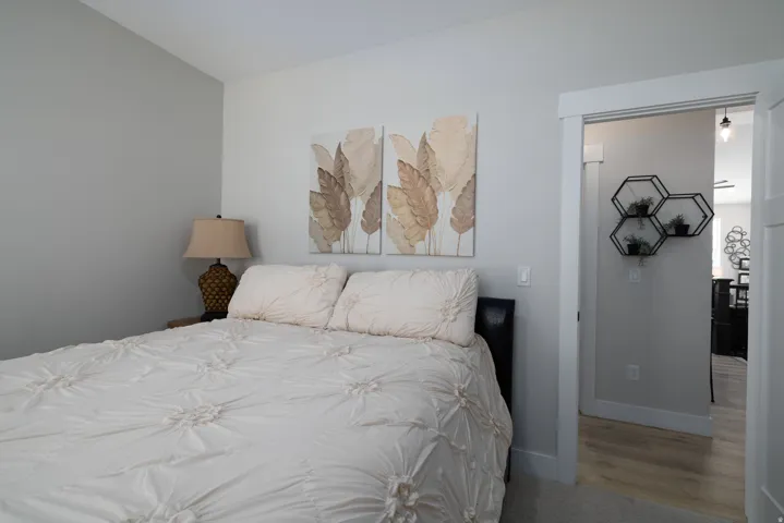 Carpeted bedroom featuring light gray painted walls and white trim