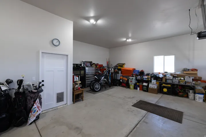 Spacious garage featuring concrete flooring and white painted walls