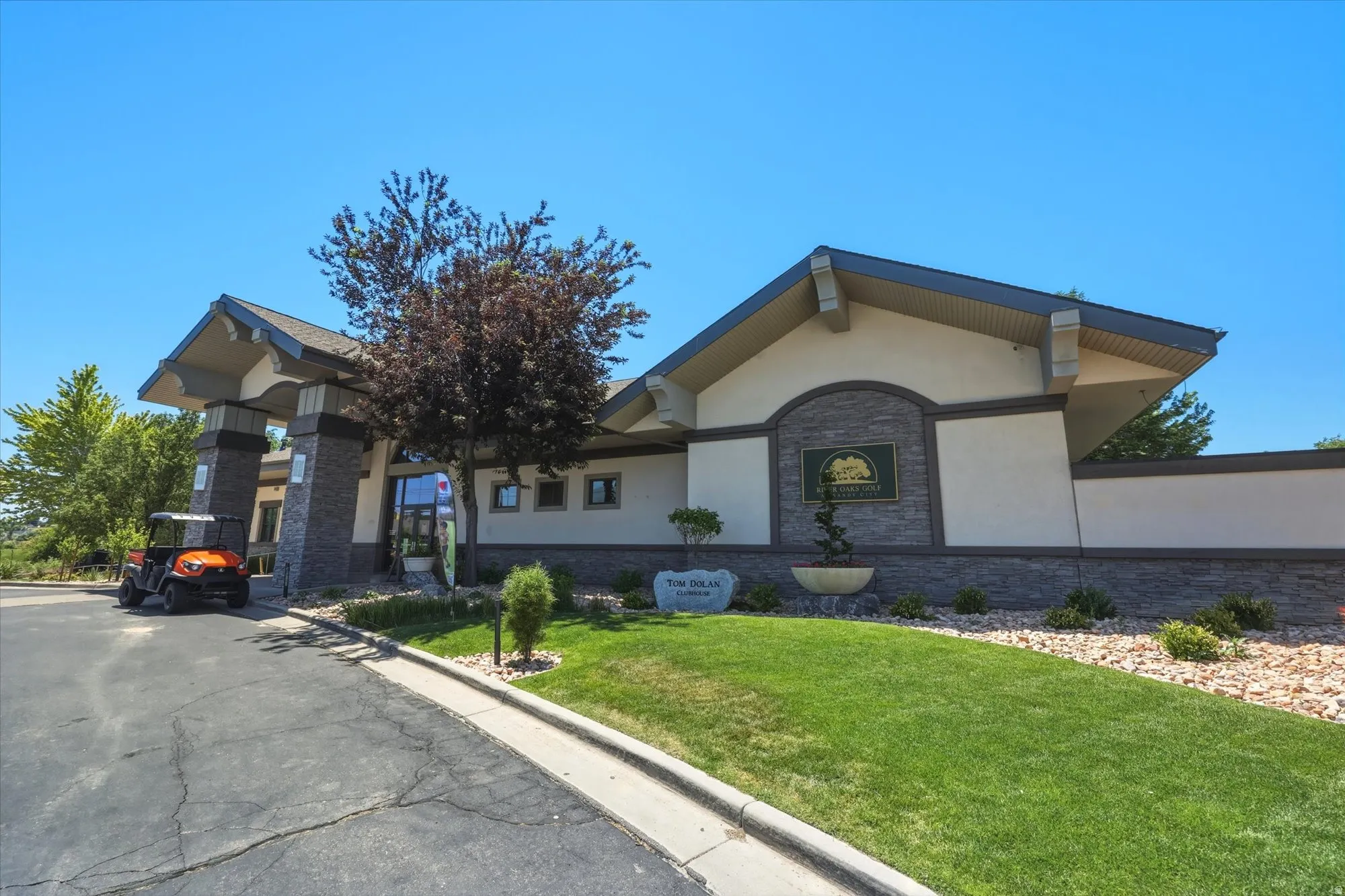 Building exterior featuring stone veneer accents, stucco siding, and a prominent entrance canopy