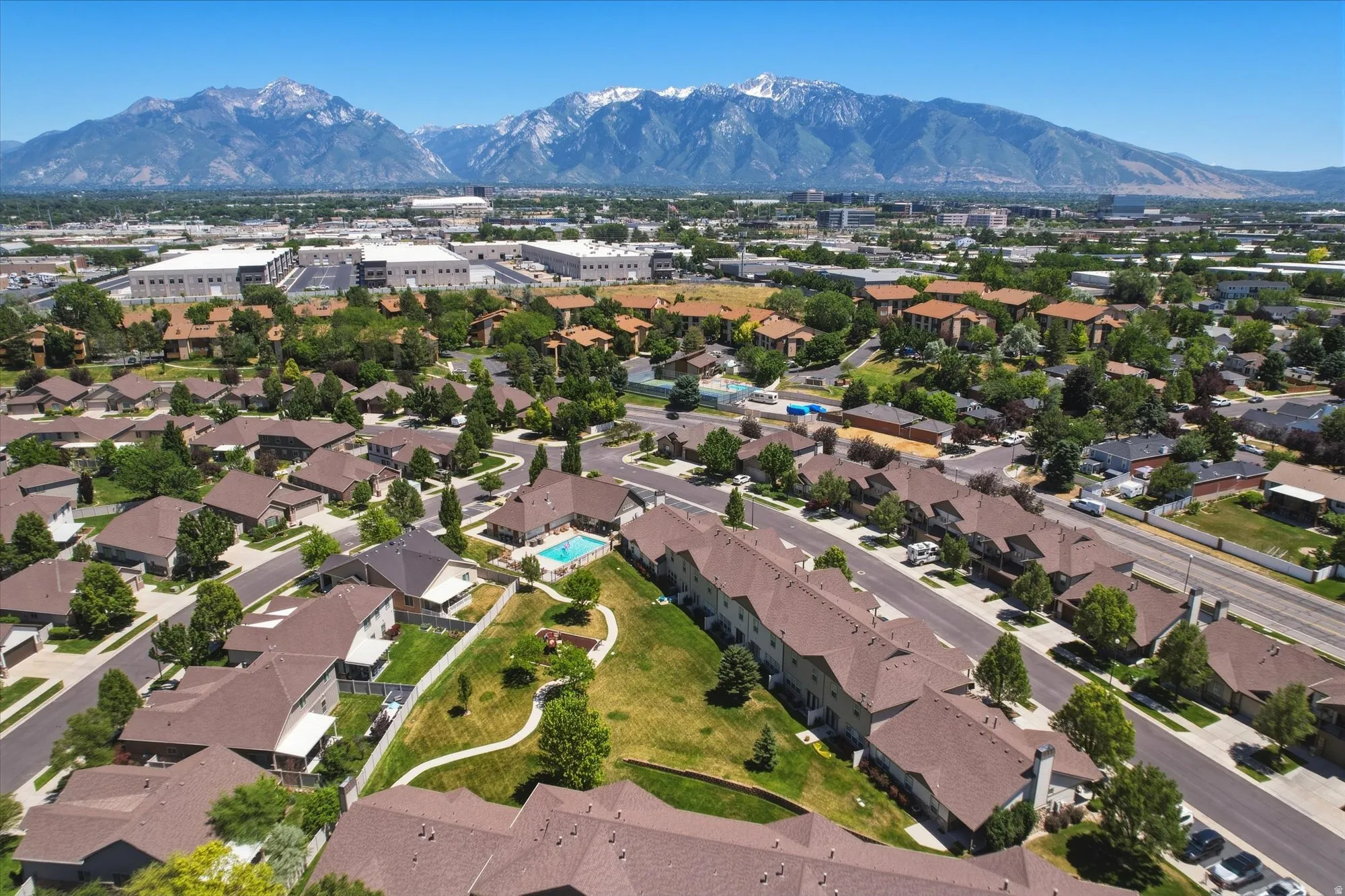 Aerial perspective showcasing a residential community with abundant mature trees and varied architectural styles