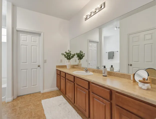 Expansive vanity with a light-toned countertop and dual integrated sinks