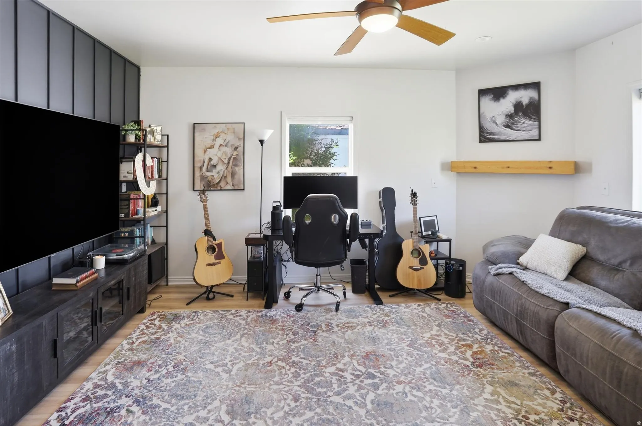 Versatile living space with light wood-finish flooring