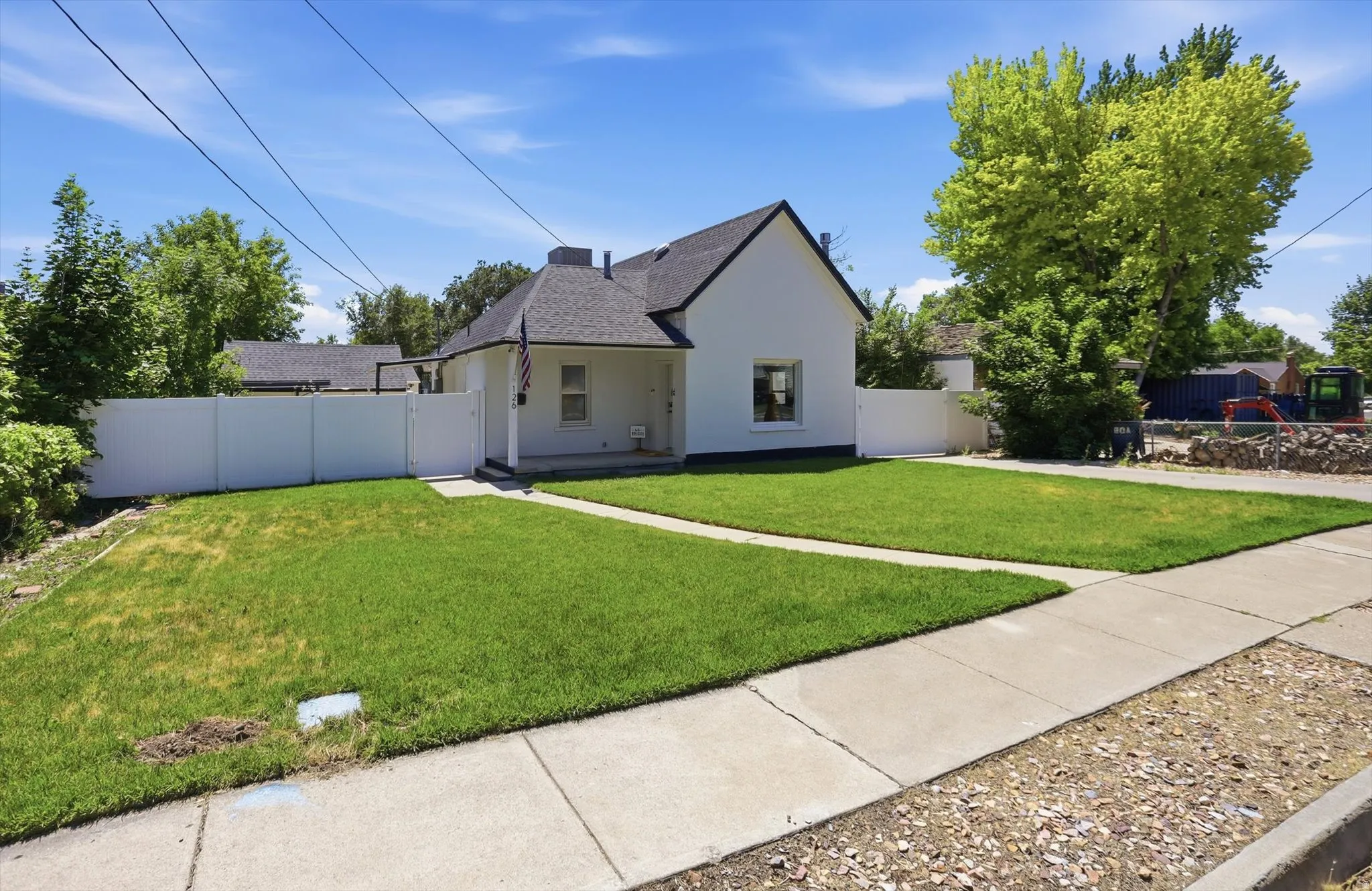 White exterior with a dark-pitched roof and covered front entry