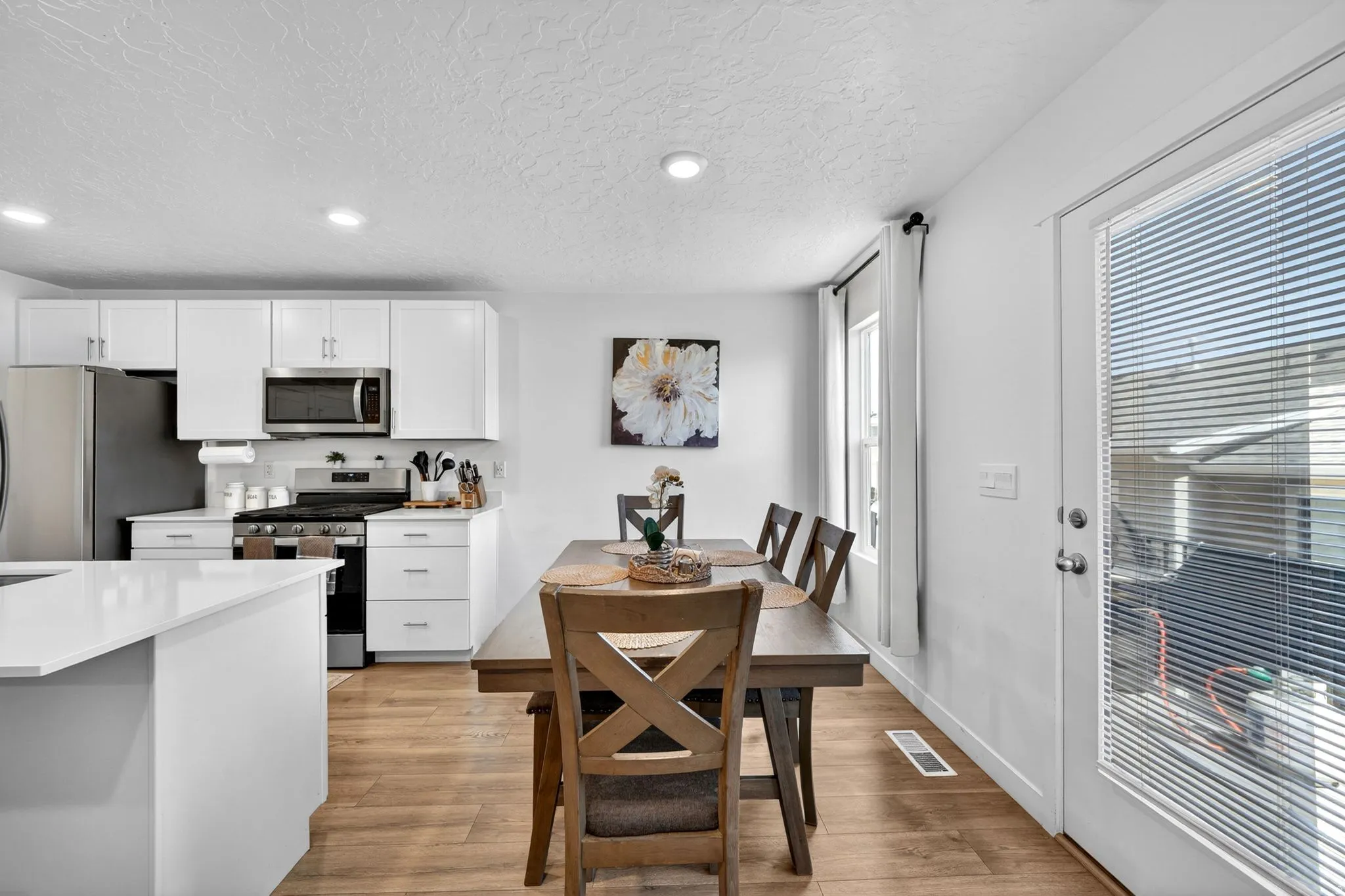 Kitchen and dining area featuring wood-finish flooring