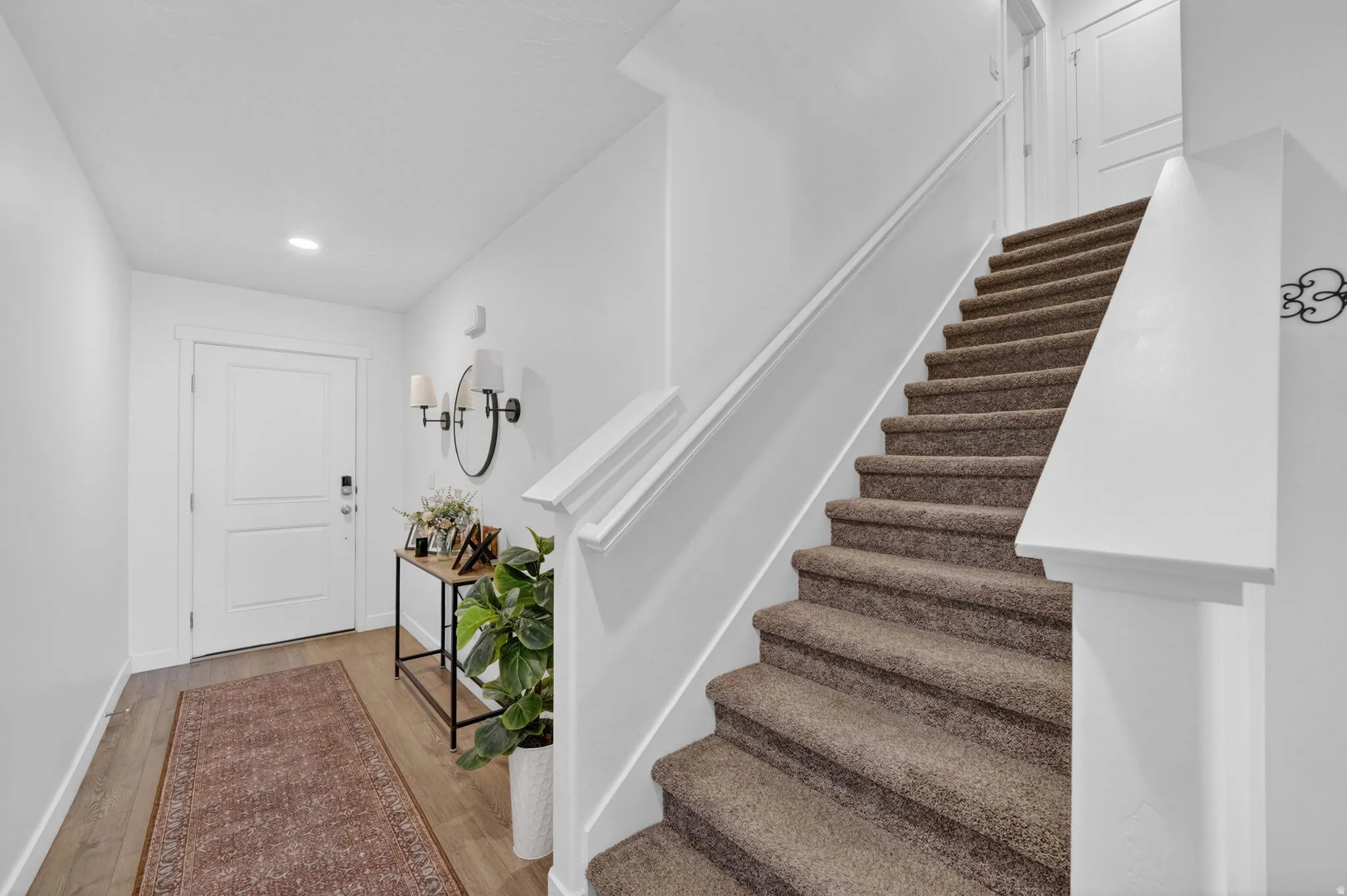 Entryway featuring wood-finish flooring and recessed lighting