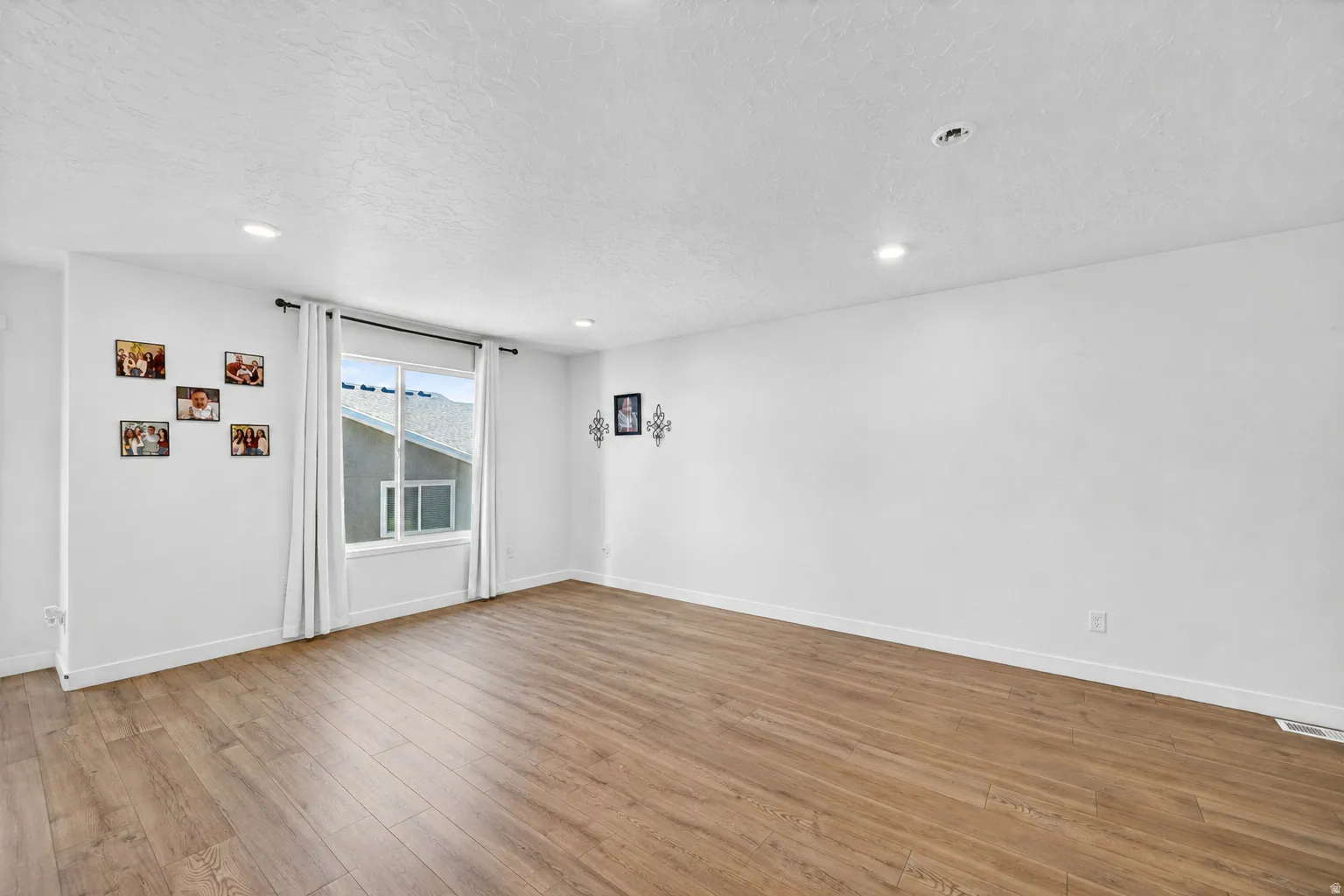 Spacious interior with wood-finish flooring and recessed lighting