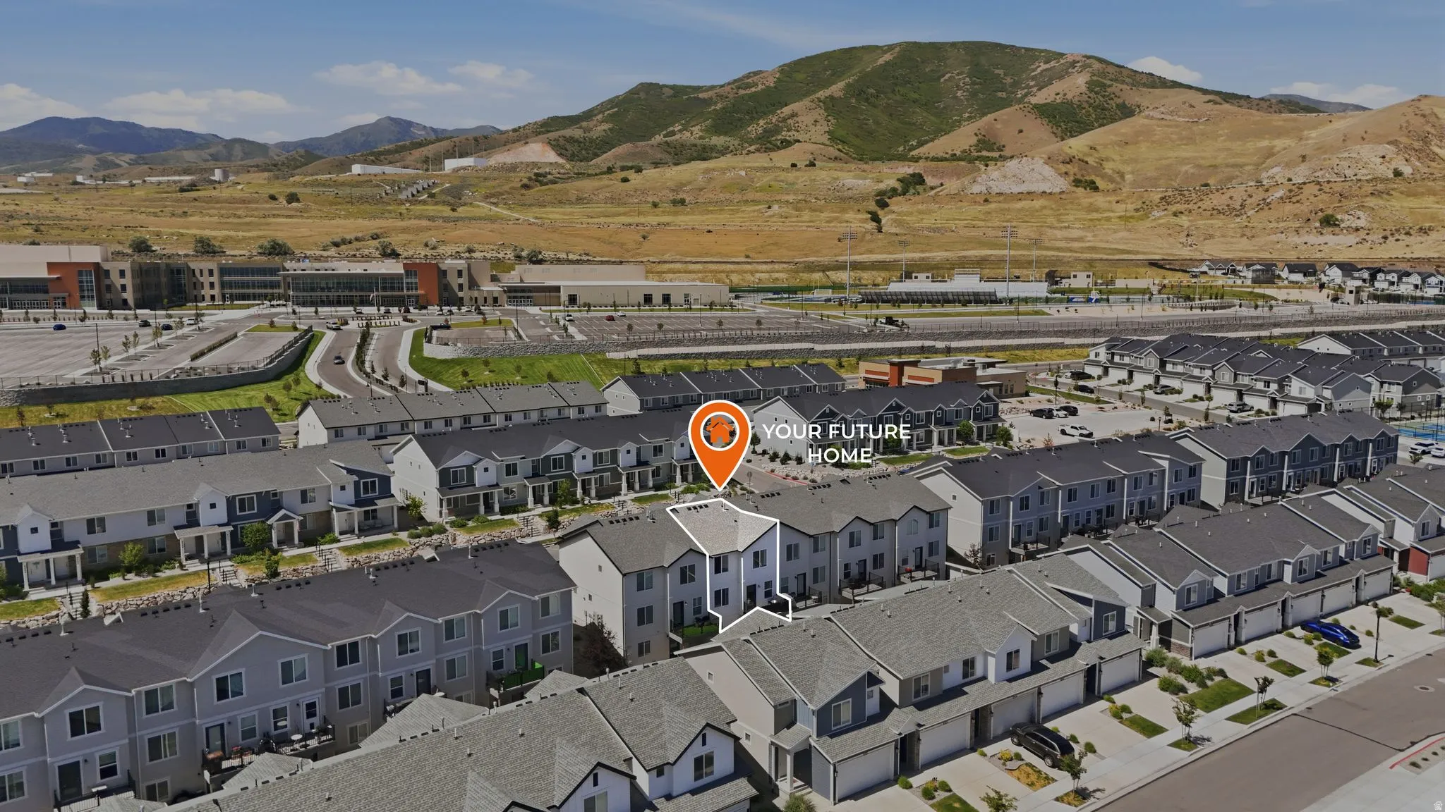 Aerial perspective showcasing a modern townhome community with mountain backdrops