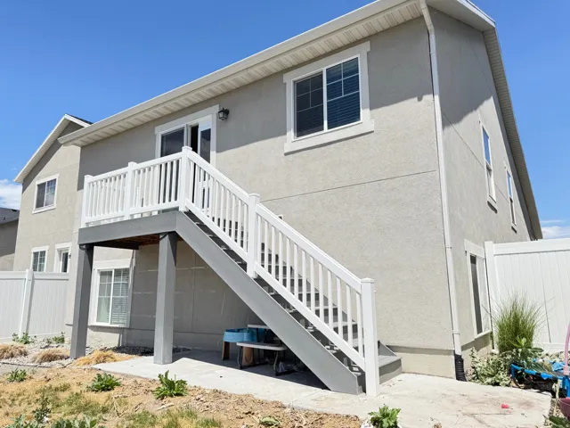 Rear exterior featuring a stucco finish