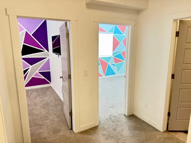 Two rooms featuring geometric accent walls, one in shades of purple, black, and gray, and the other in blue, pink, and white