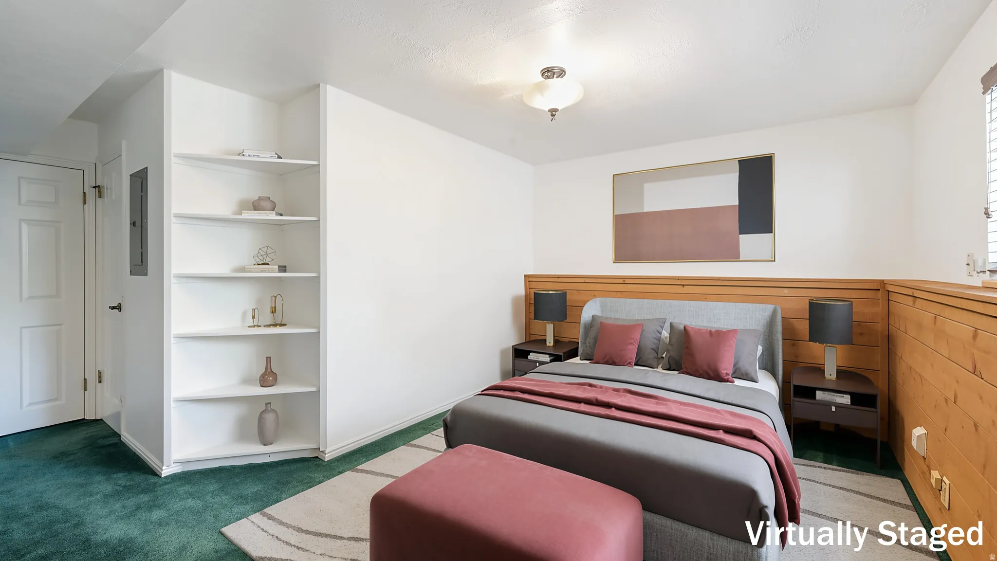 Bedroom featuring wood paneling, corner built-in shelving, white walls, green carpeting, and a built-in overhead light fixture