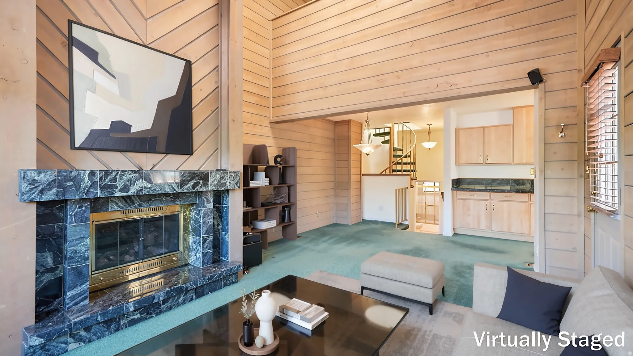 Living area featuring a stone-clad fireplace with a brass firebox, wood-paneled walls, and soft green carpeting
