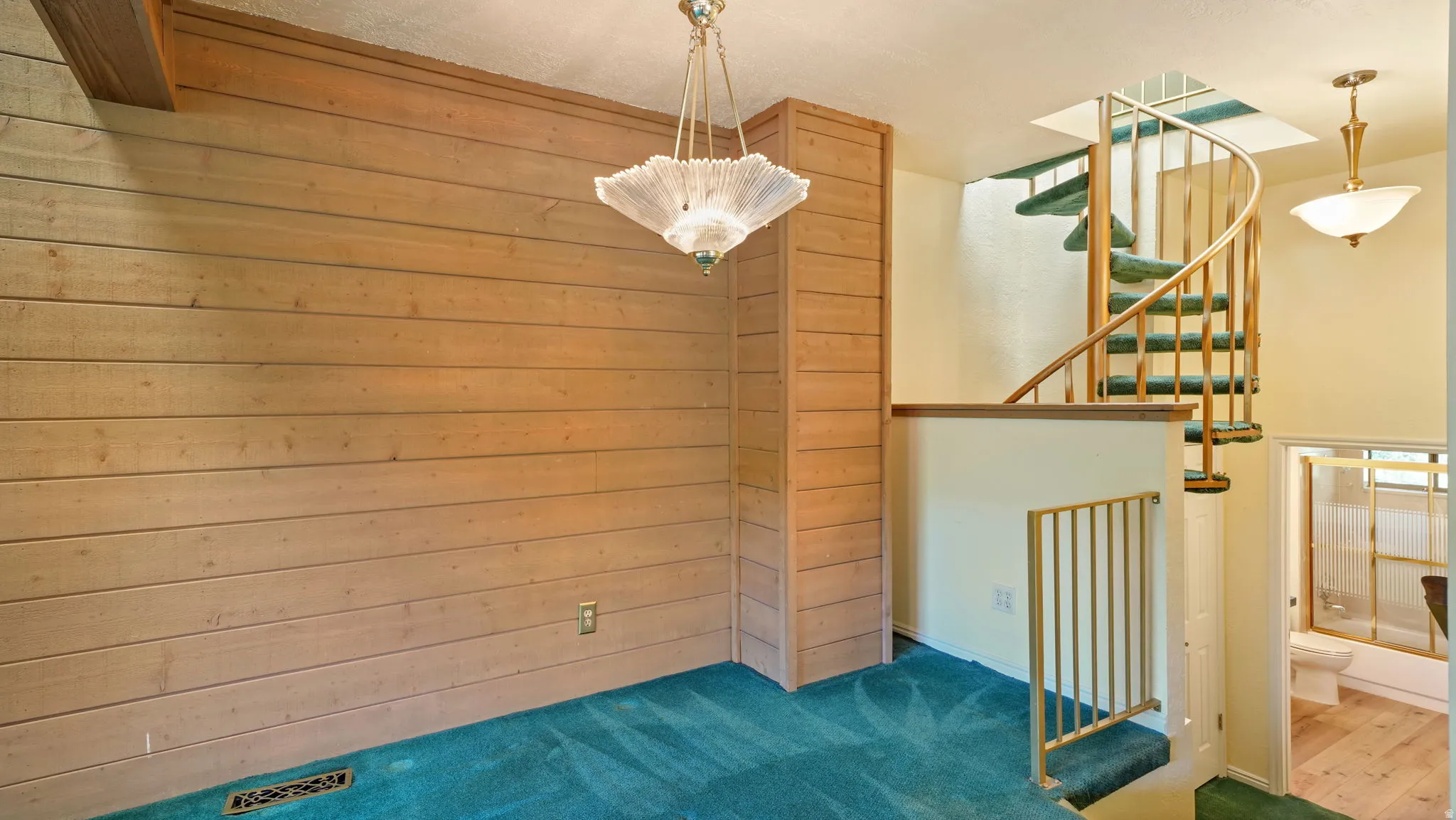 Wood-paneled accent wall with a prominent decorative light fixture