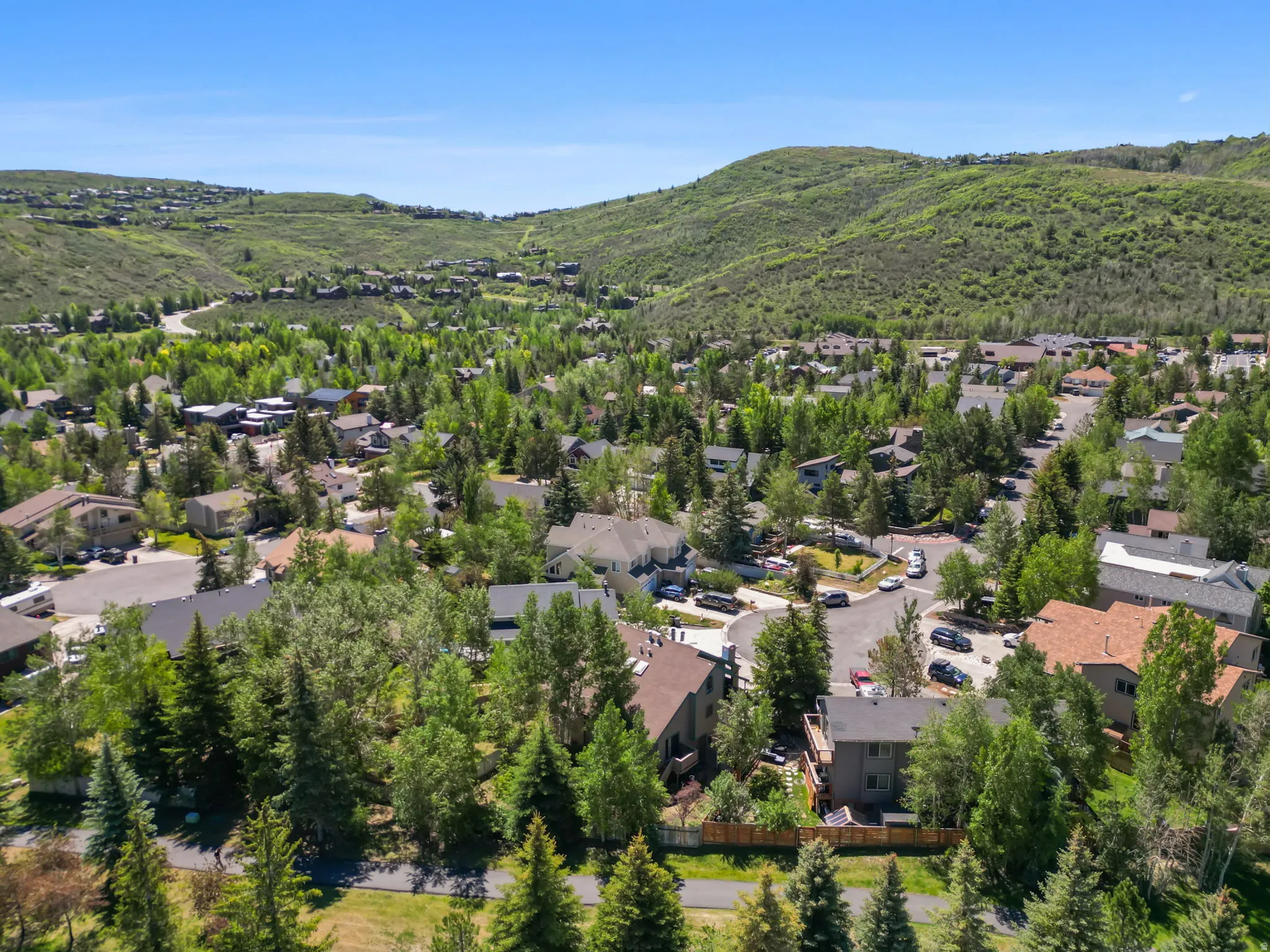 Expansive mountain landscape featuring residential properties amidst lush green hills