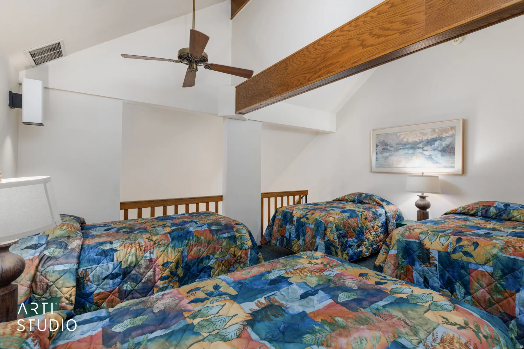 Vaulted ceiling room featuring exposed wood beams and a ceiling fan
