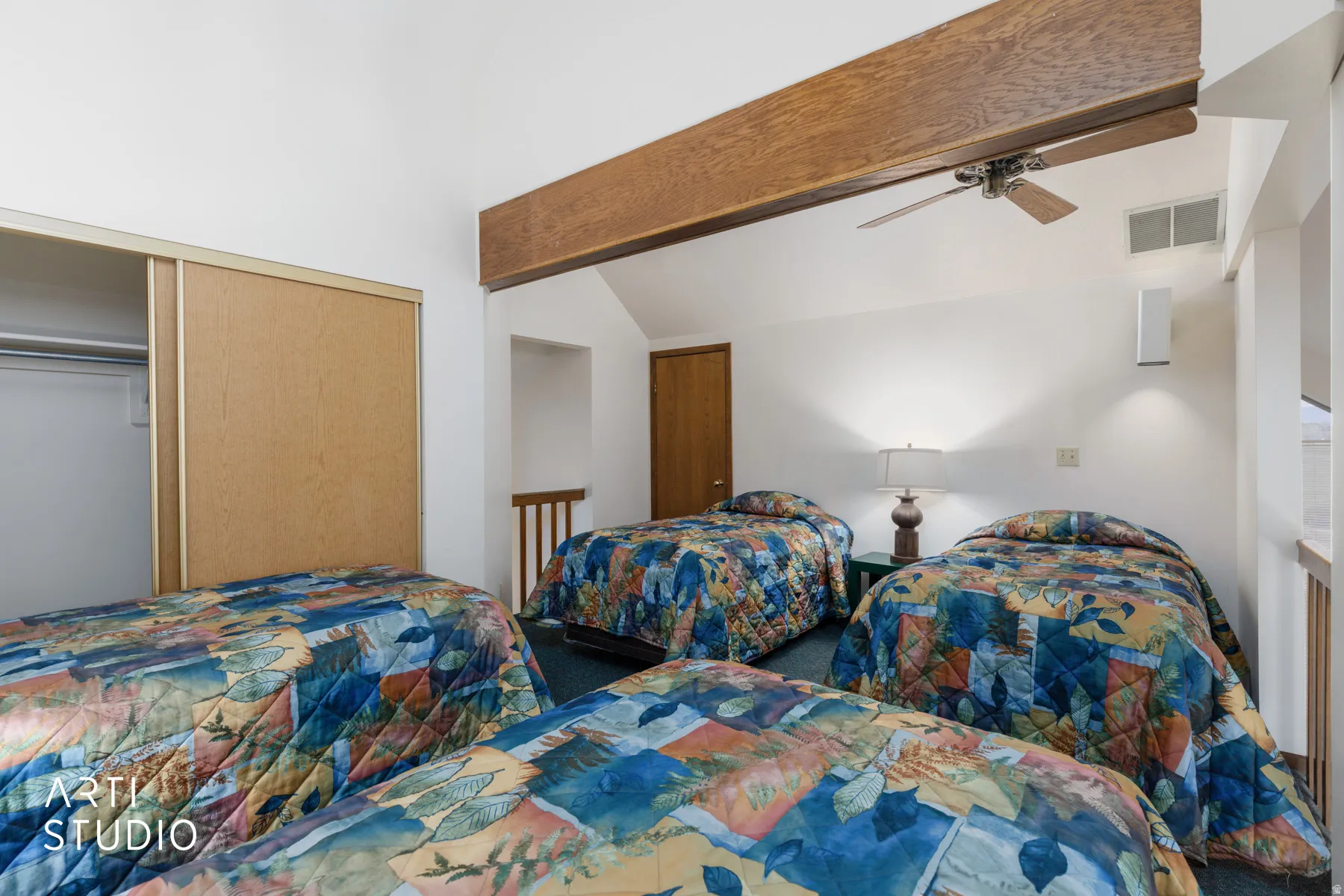 Loft sleeping area featuring high vaulted ceilings, a wood beam accent, and a ceiling fan