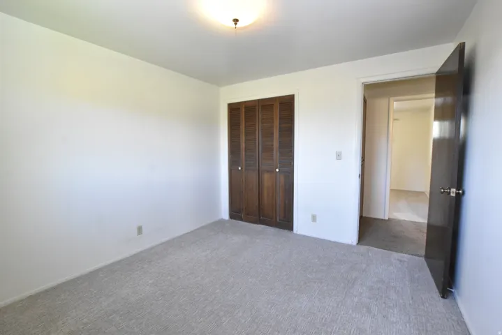 Neutral-toned wall paint and light-colored carpet flooring create a bright interior