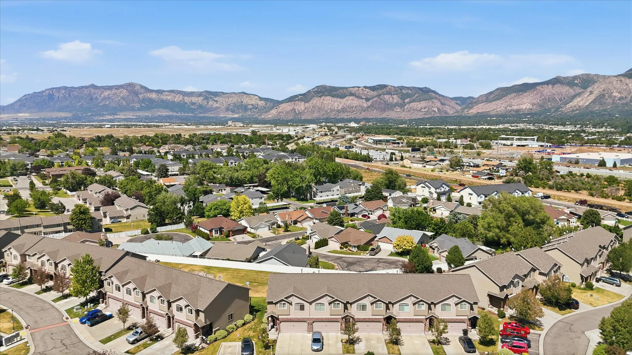 Residential neighborhood with extensive tree coverage and prominent mountain backdrop
