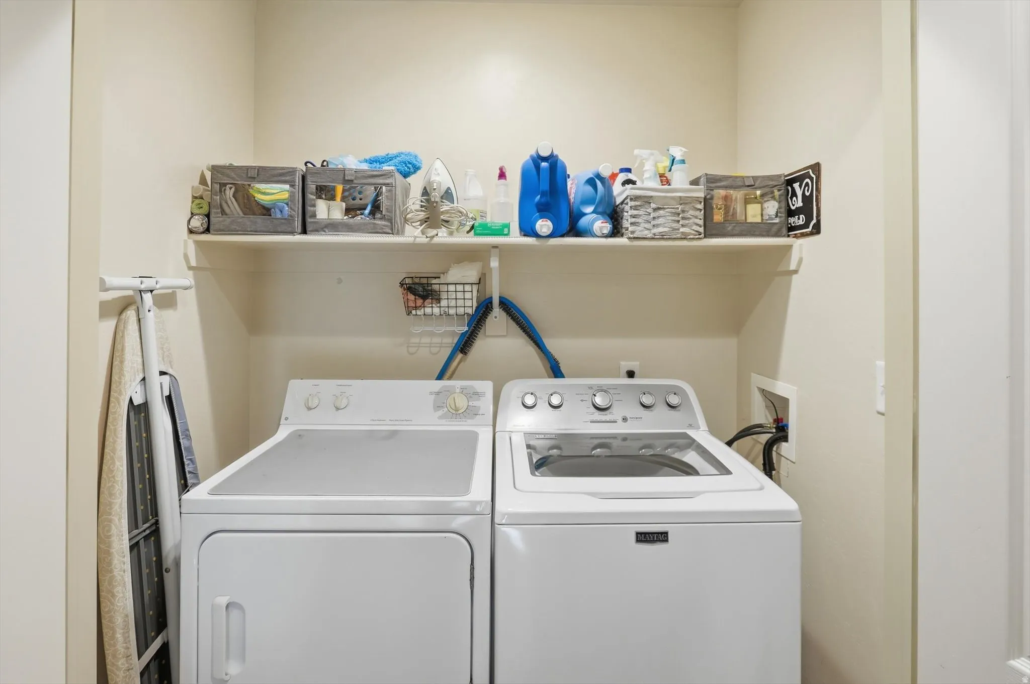 Dedicated laundry alcove with convenient overhead shelving