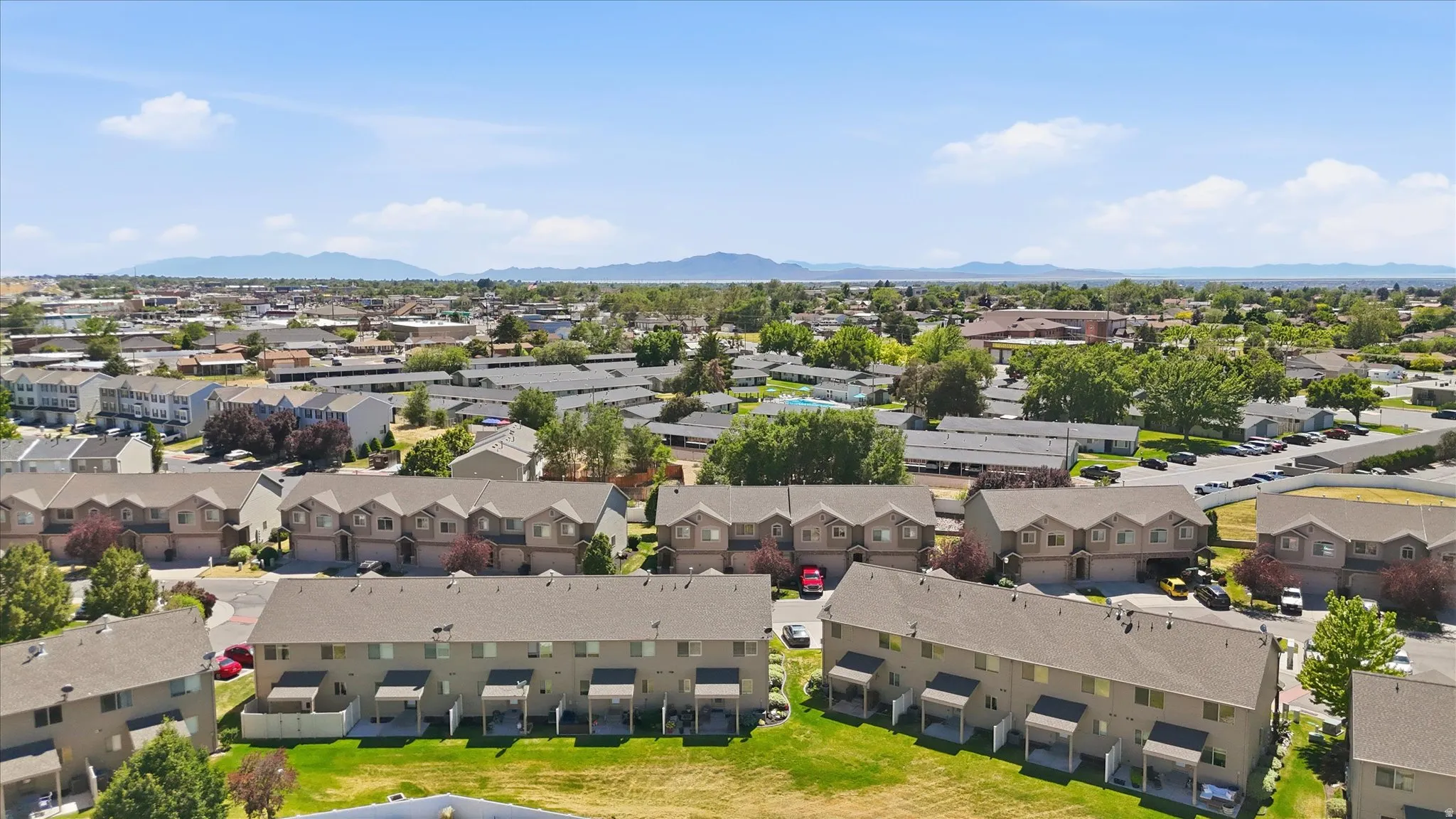 Aerial perspective showcasing a residential community with multi-level townhome-style residences