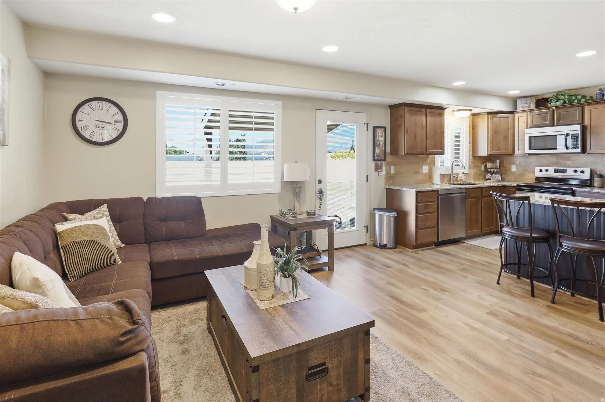 Open concept living area featuring wood-finish flooring