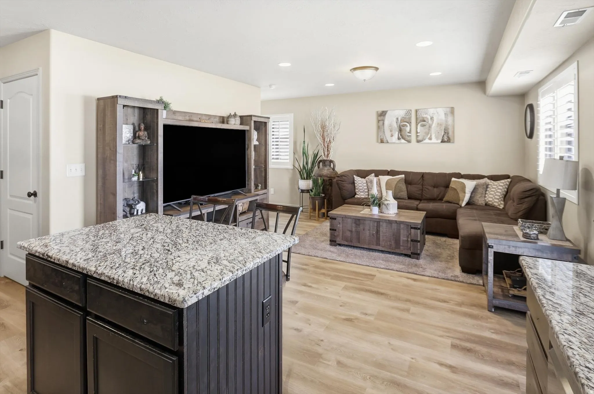 Kitchen island featuring a speckled countertop and beadboard paneling