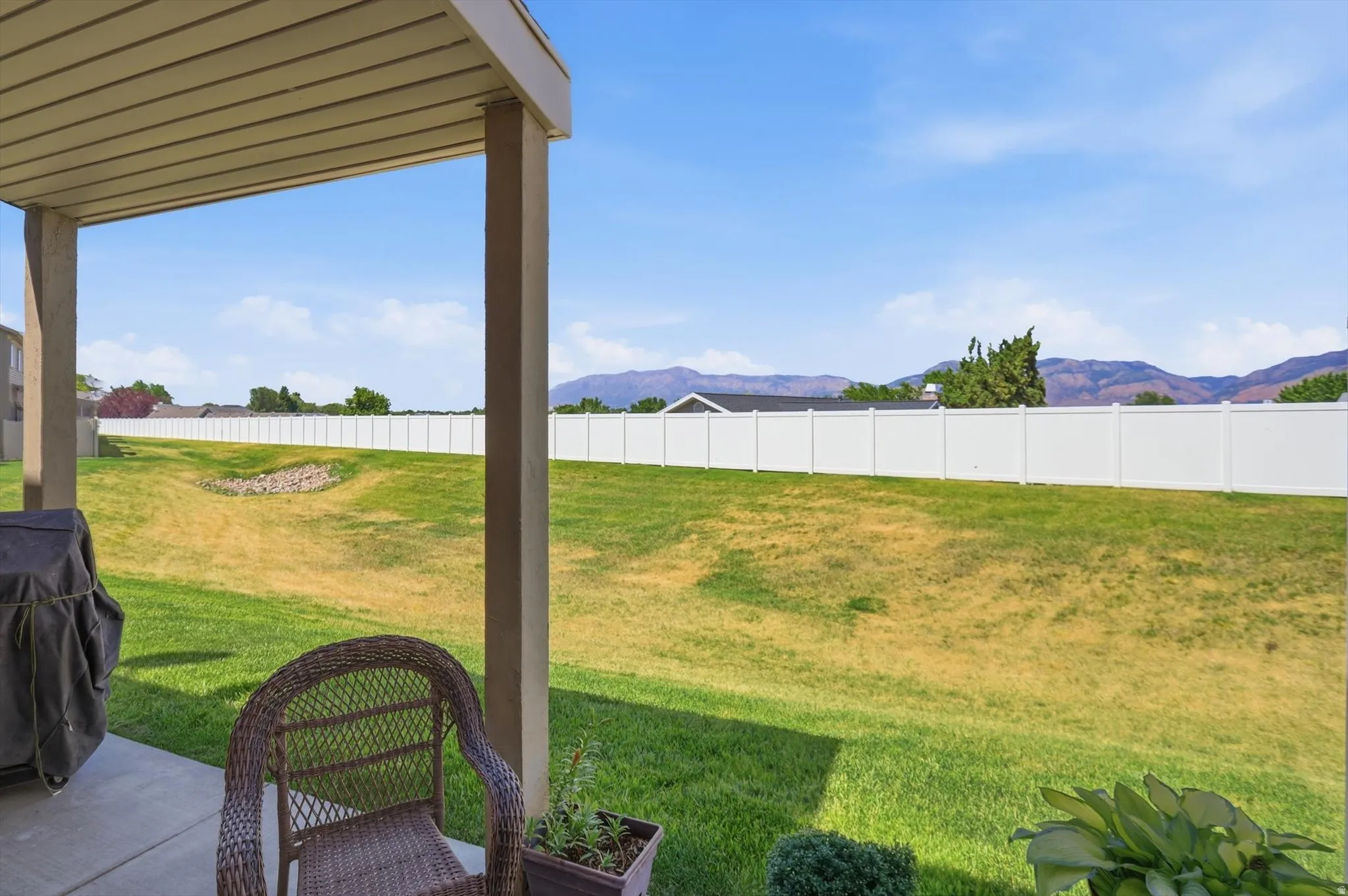 Covered patio with a concrete surface, providing exterior living space