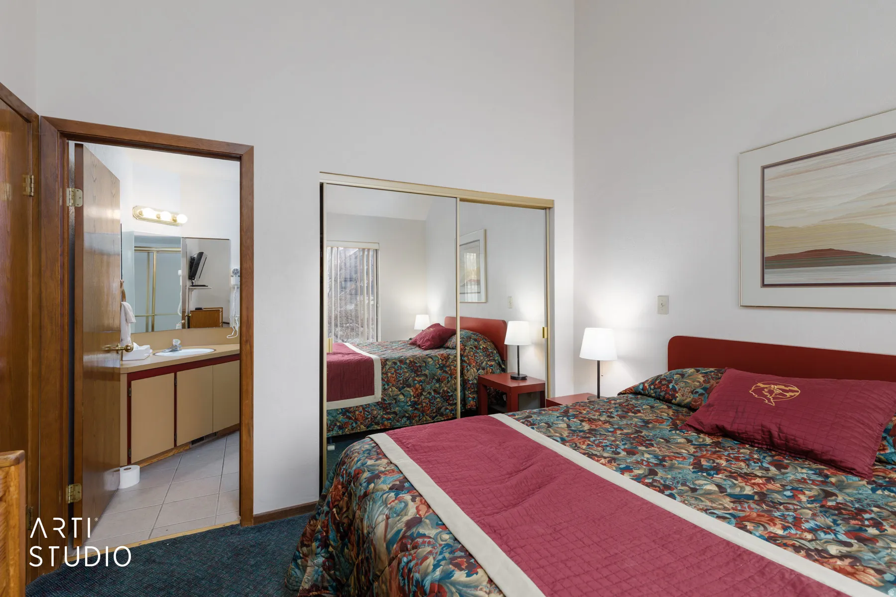 Bedroom featuring a vaulted ceiling and sliding mirrored closet doors
