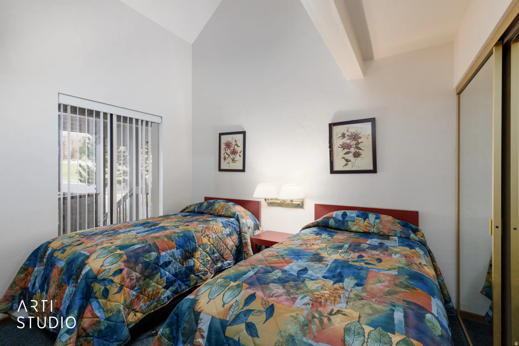 Vaulted ceiling room featuring a sliding glass door with vertical blinds, wall-mounted lighting, and mirrored closet doors