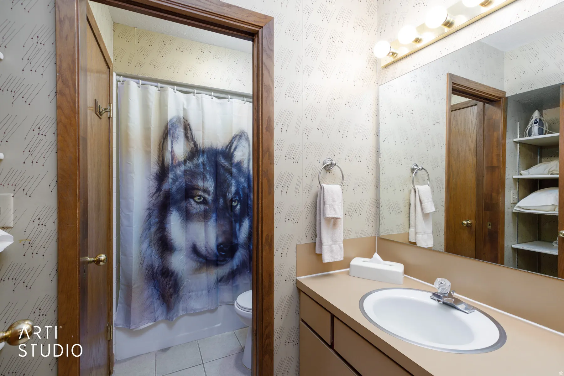 Bathroom vanity with an integrated sink, polished chrome faucet, and expansive wall-mounted mirror