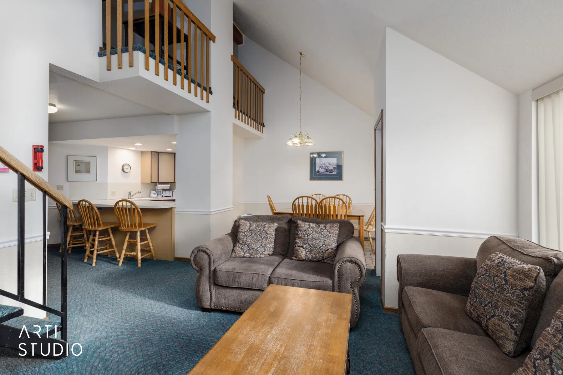 Vaulted ceilings enhance the main living area featuring plush carpeting