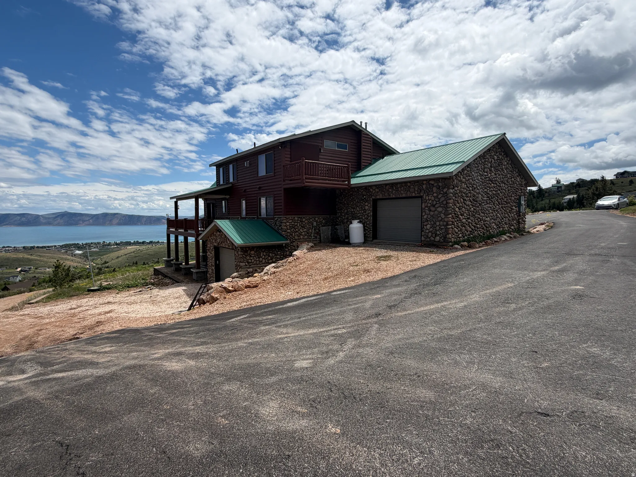 Two-story residence with a lake and distant landscape backdrop