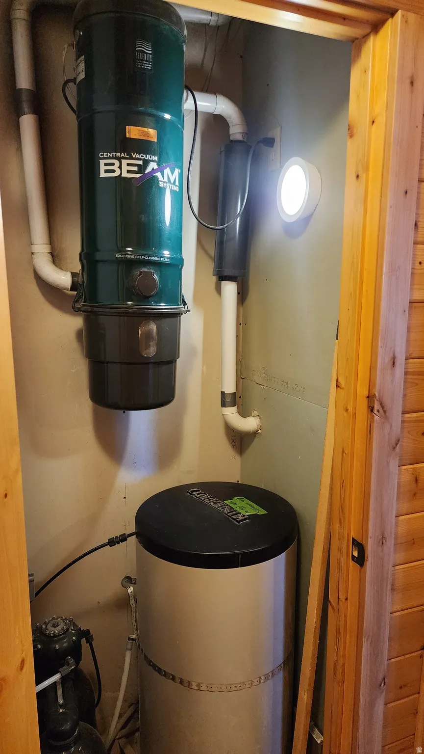 Central vacuum system and water filtration unit in a dedicated utility space