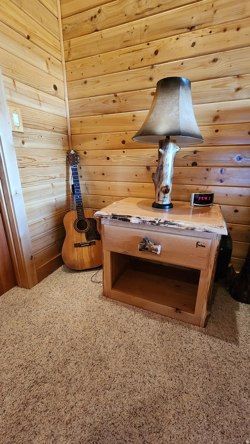 Wood-paneled walls featuring horizontal planking and a light wood-finish door frame