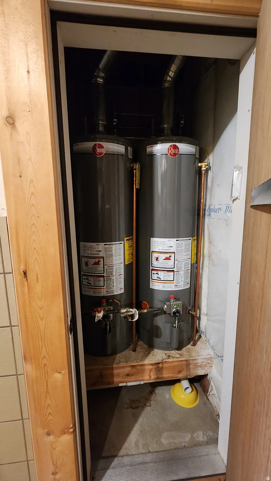 Dual Rheem water heaters installed on a wood platform